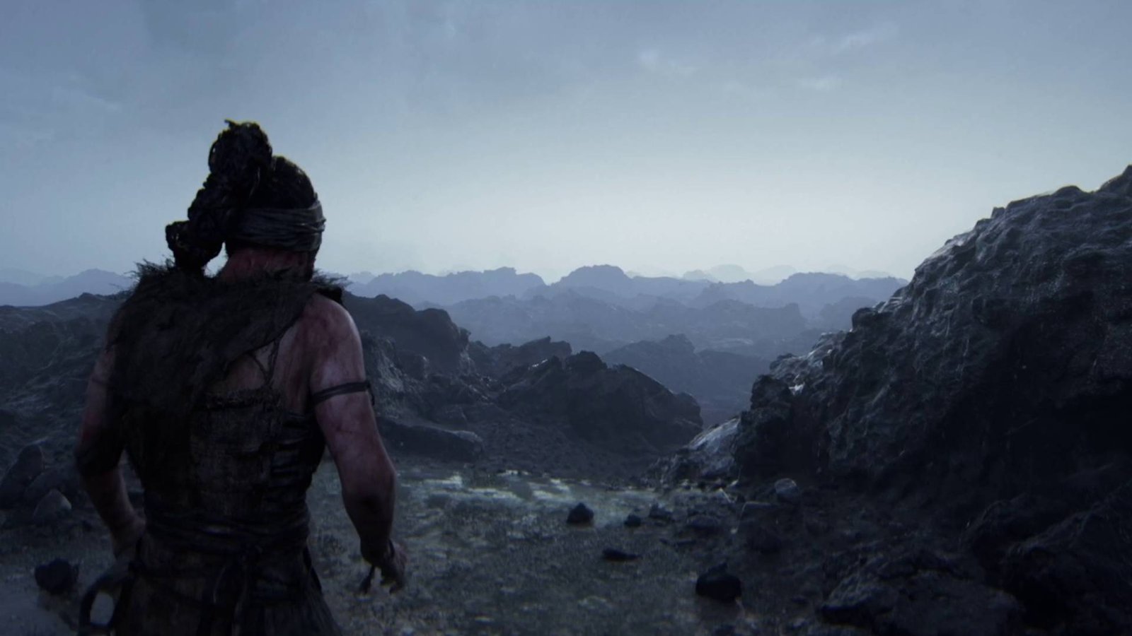 Senua's Saga Hellblade 2 Senua looking at rocky mountains